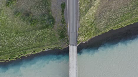 two rivers blending together in iceland with bridge, confluence phenomenon