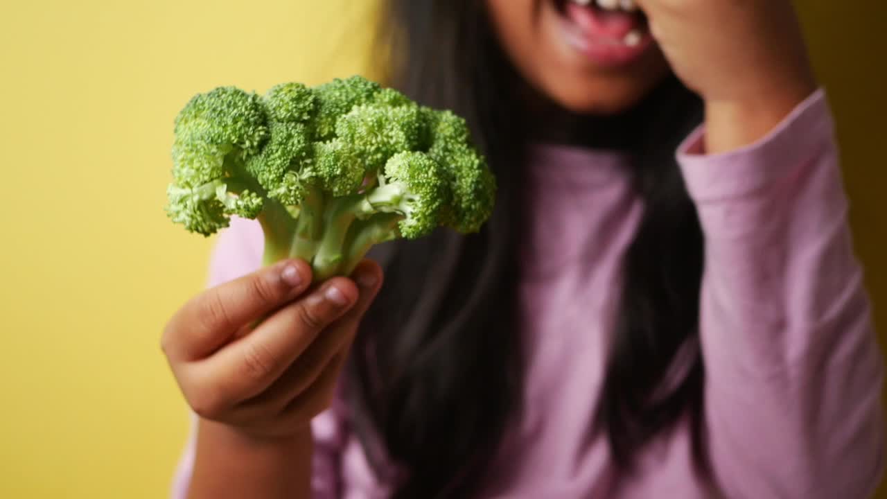 Child Holding Broccoli