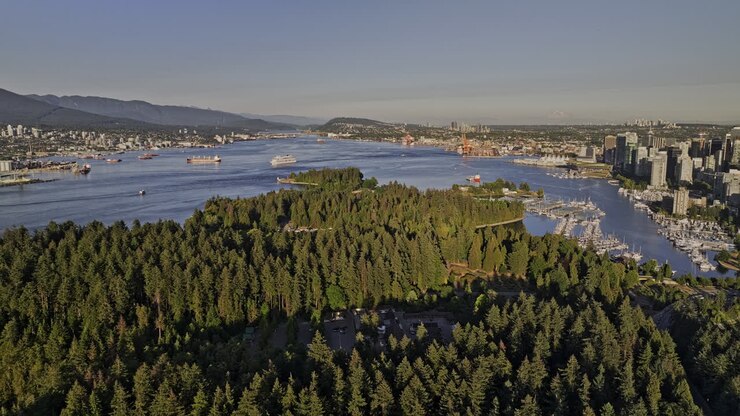 Vancouver BC Canada Sorvolo aereo con drone v50 di Stanley Park che cattura il paesaggio urbano del centro di Coal Harbour, il porto turistico, lo yacht club e le viste sulle montagne della costa nord - Ripreso con Mavic 3 Pro Cine - Luglio 2023