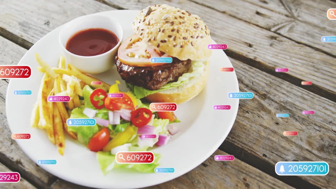 Animation of hamburger with salad and fries, colorful tags surrounding plate