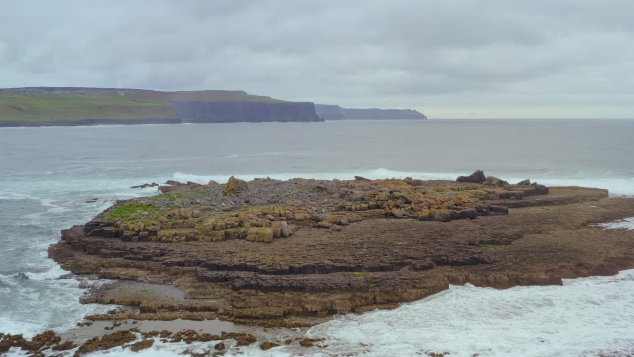 Unique shot of the Cliffs of Moher framed with Crab Island in the foreground. Aerial dolly