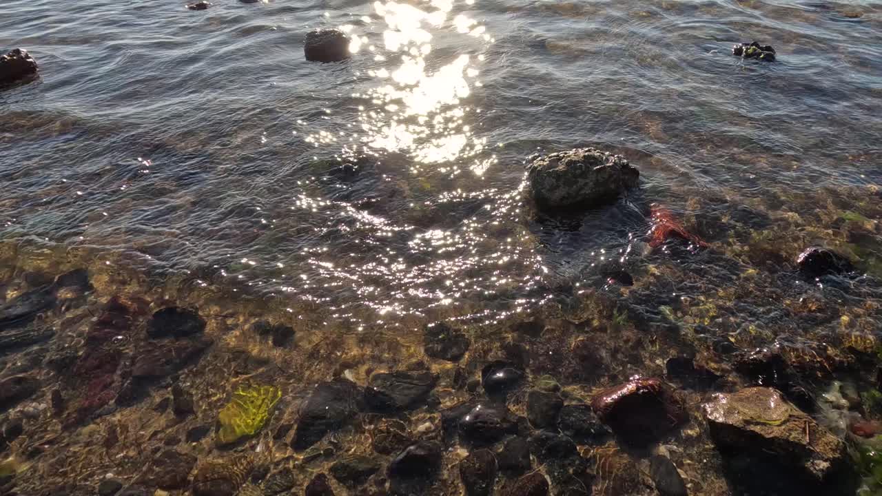 Waves gently hitting rocks at Brighton Beach