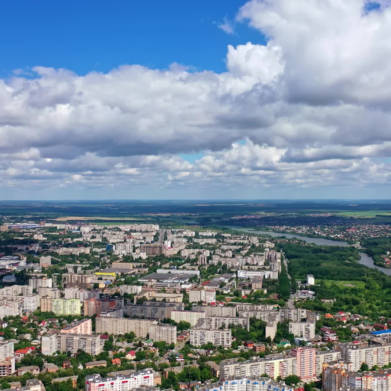 Beautiful cityscape. Panorama of a city under white clouds. Modern downtown in summer. Aerial view.