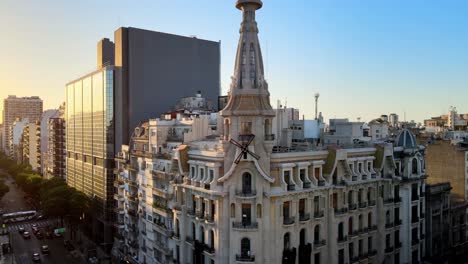 aerial orbit of el molino historic art nouveau building recently restored in busy buenos aires at golden hour, argentina