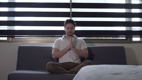 young handsome man pretanding o meditate