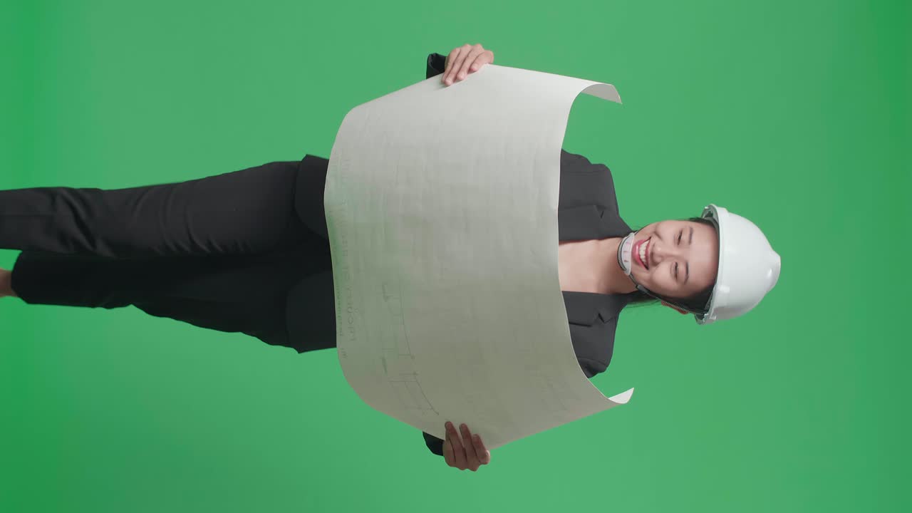 Asian Woman Engineer Holding Architectural Drawings