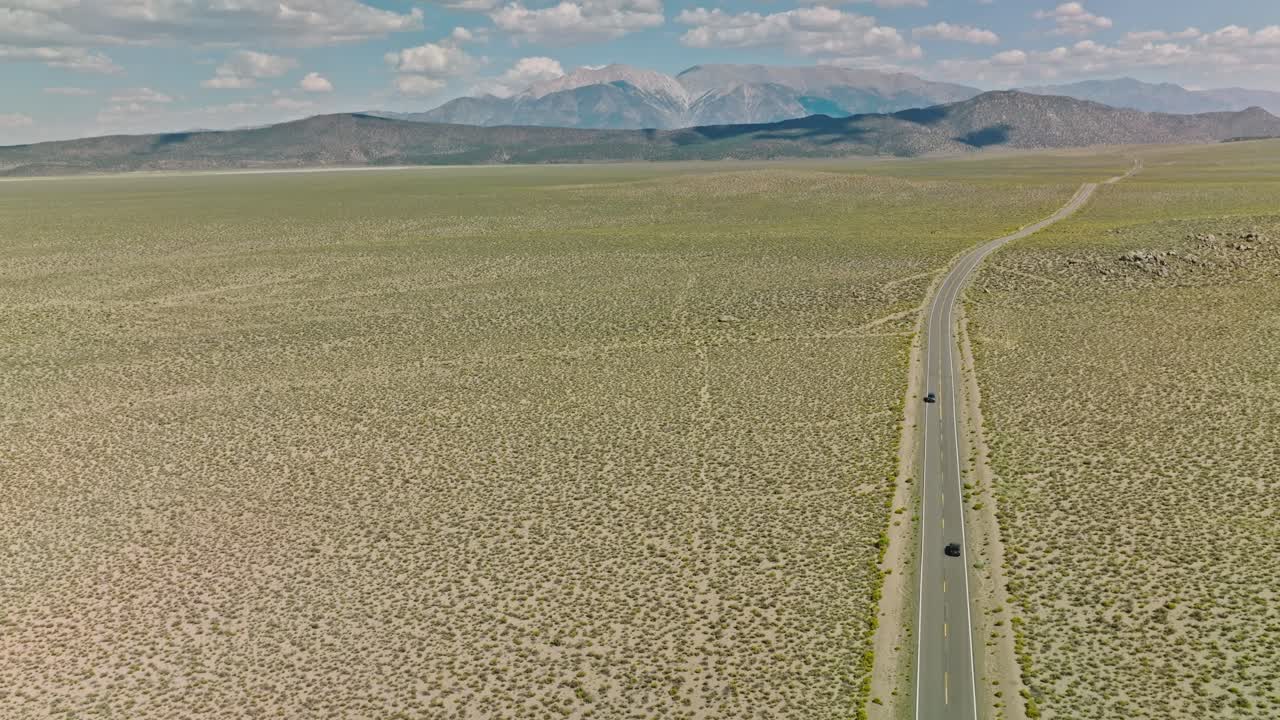Car Driving Down a Nevada Desert Road