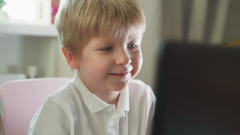 preschooler opens mouth excitedly looking at computer screen