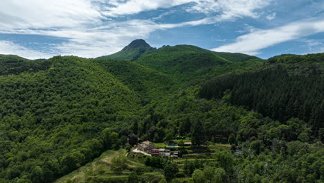 cloudscape casting shadow of forestry mountain of montseny, aerial drone view