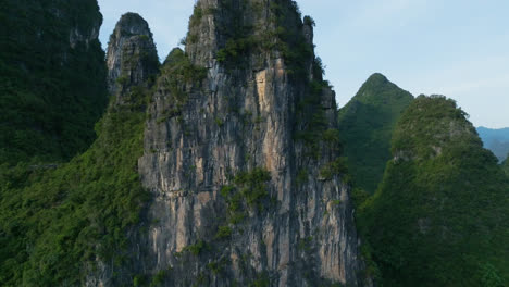 aerial view circling a rocky, karst mountain peaks, sunset in xingping, china