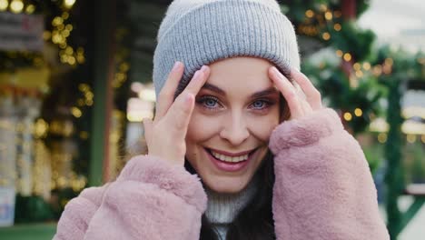 handheld view of beautiful woman in winter clothes