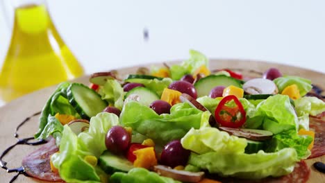 sauce being poured in salad