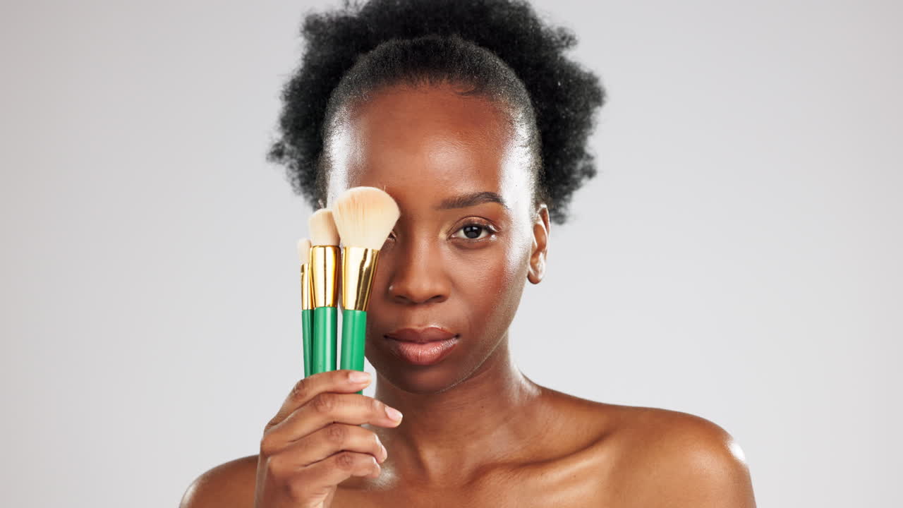 Face, makeup and black woman with brushes