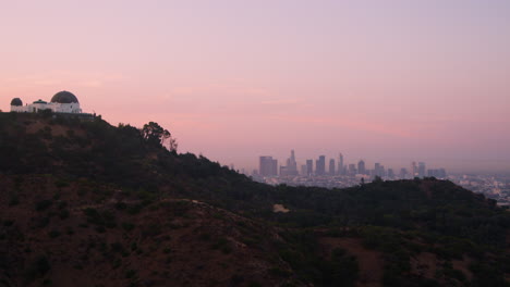 a pink dawn sky over griffith park the