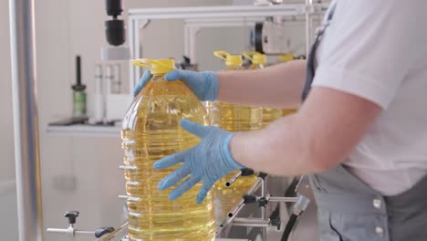 sunflower oil in the bottle moving on production line. bottling line of sunflower oil in bottles. vegetable oil production plant. high technology. industrial background