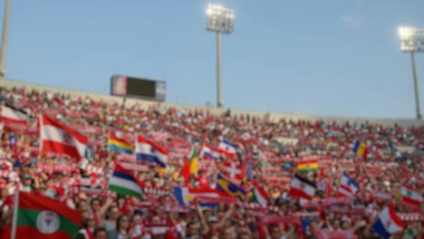 vibrant stadium atmosphere: a sea of flags and fans unite in excitement and passion for their team, celebrating together in a joyous sporting event