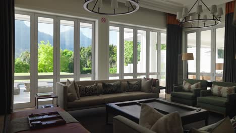 living area within a modern luxury house showing tasteful furniture and beautiful views outside of large windows