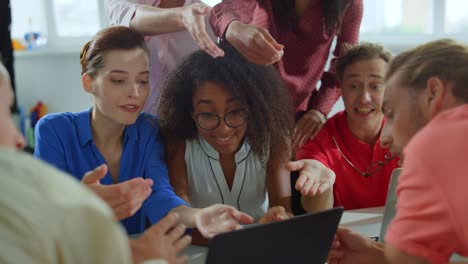 multiethnic creative people working with computer in meeting room