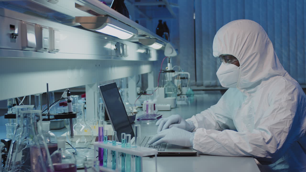 Epidemiologist in Protective Coveralls Working and Posing in Lab