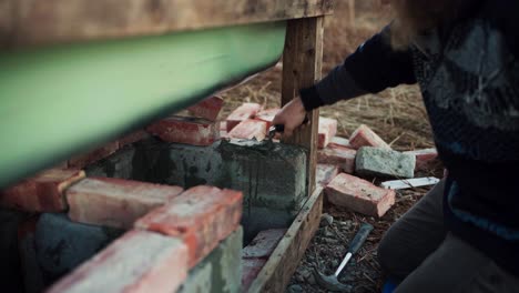 Person-Is-Laying-A-Brick-Wall