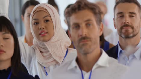 female audience member at a business conference asking a question