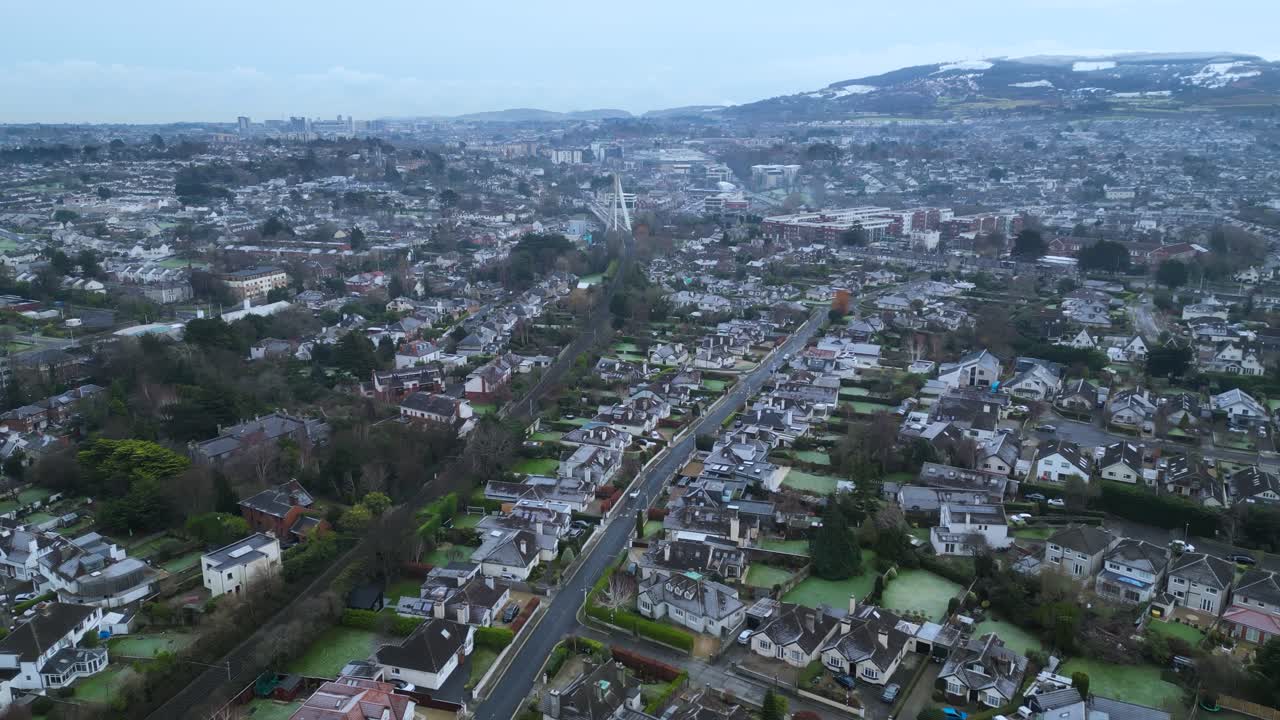aerial view of South Dublin - The suburbs of Dundrum, Churchtown and Milltown with the famous Dublin Mountains in the background covered by snow during a cold winter day. Ireland