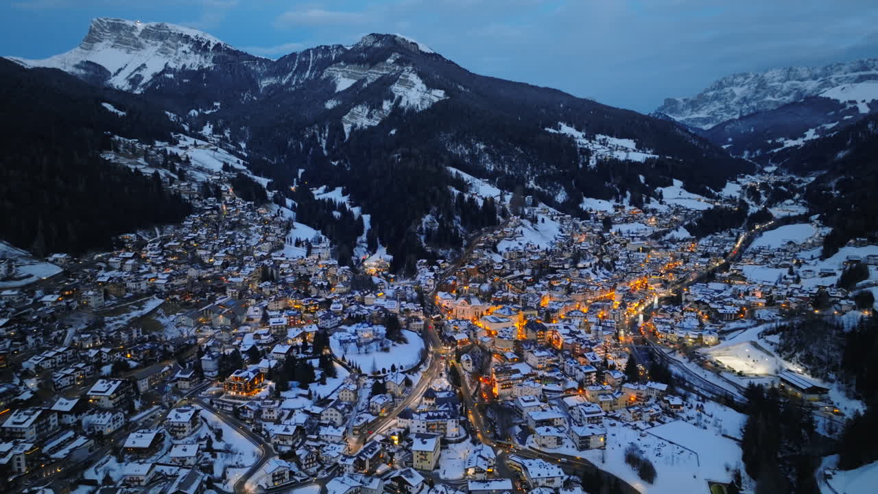 Aerial drone view of the Ortisei town covered in snow, within the Dolomites, in northern Italy