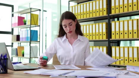 professional woman stamping documents in an office