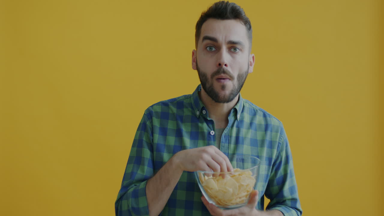 Man Surprised While Eating Chips