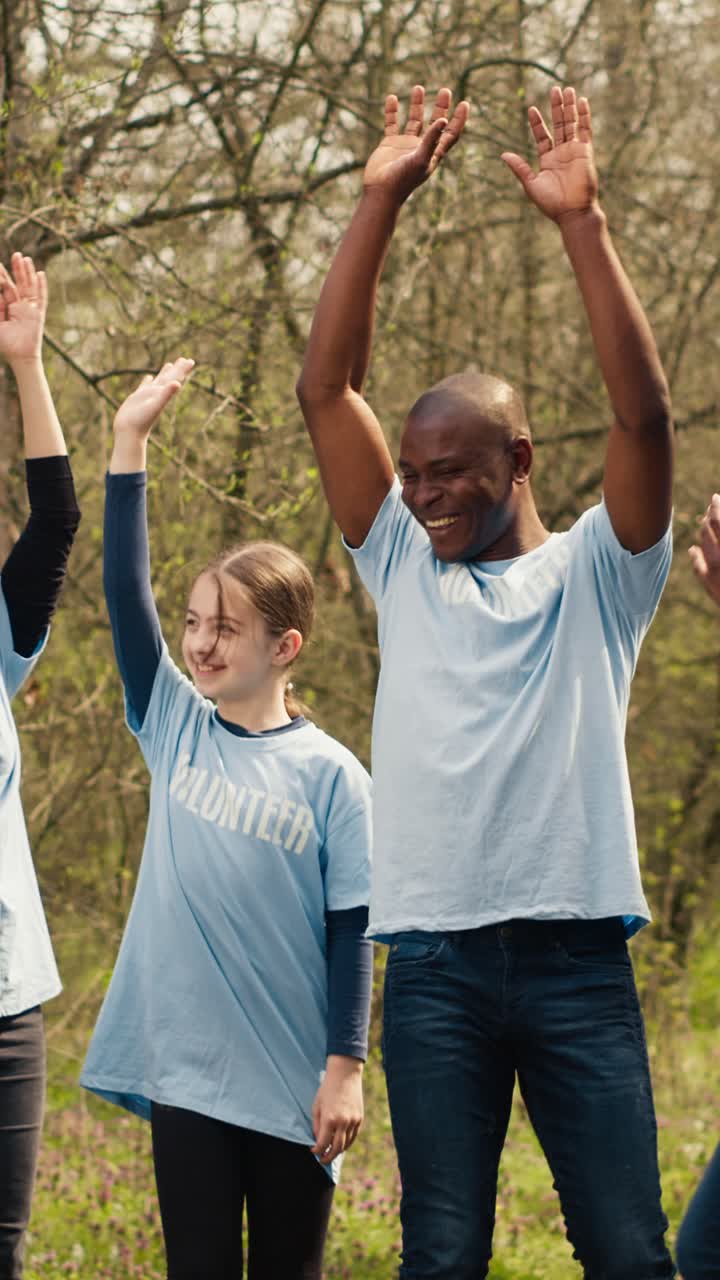 Happy Diverse Volunteers Stacking Hands and Cheering Outdoors