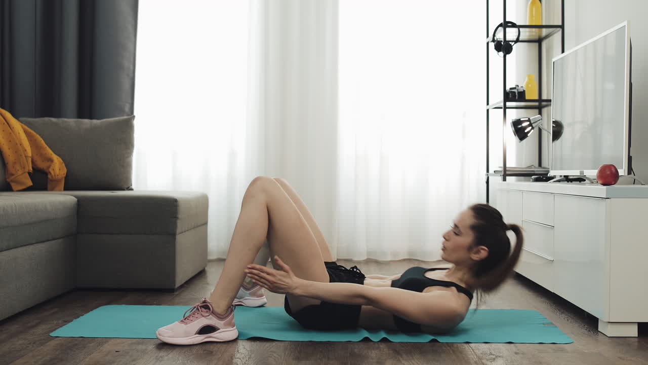 Woman doing sit-ups at home