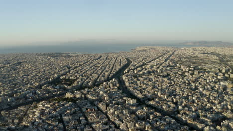 drone aerial shot over the city of athens, with the mediterranean sea in the background, greece