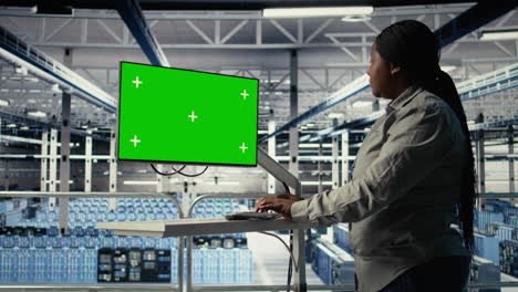 server room female programmer using green screen computer