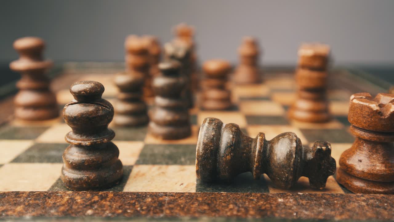 Chess king shaking and falling checkmate