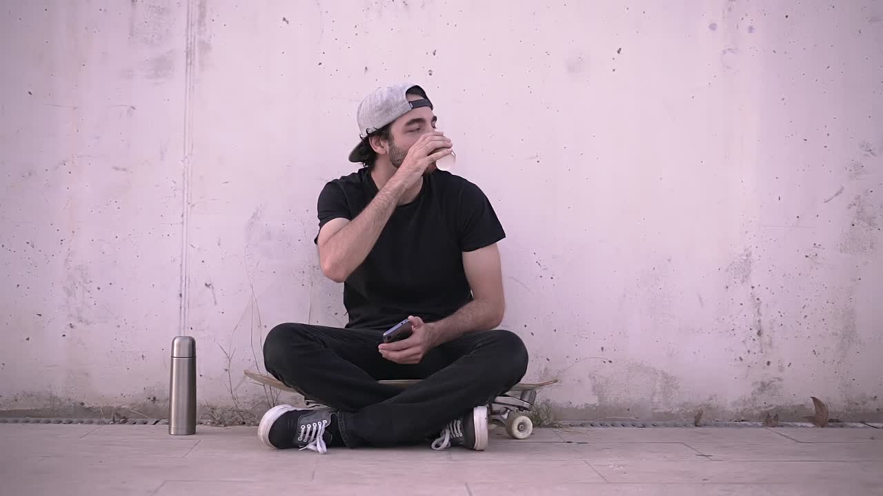 Young Man Relaxing on a Skateboard
