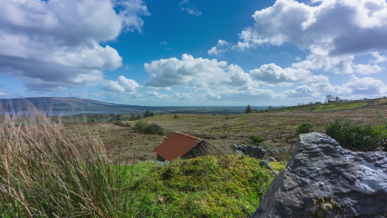 Rural Landscape with Clouds and Thatched Roof Building