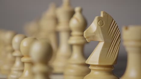 captivating rack focus with intricate details of different white chess pieces