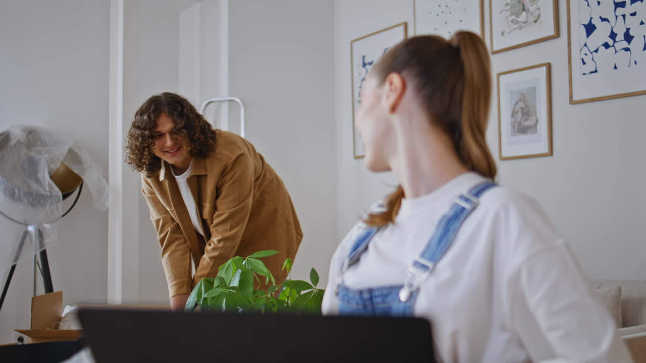 Smiling wife receiving good news by laptop sharing with husband in home closeup