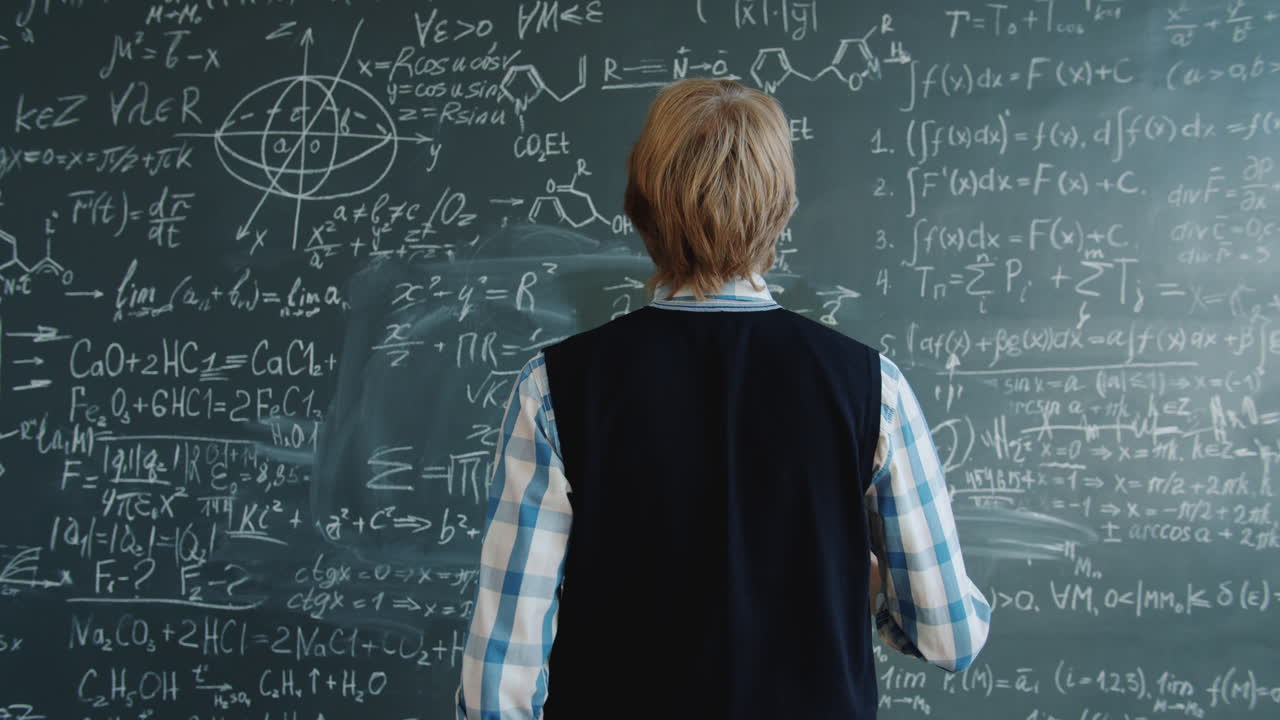 Boy Studying Complex Equations on a Chalkboard