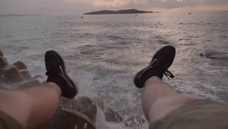 First-person-view-POV-watching-the-sun-set-into-the-Atlantic-Ocean-in-port-city-of-Essaouira,-Morocco