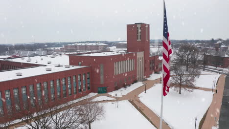 american flag during winter snow flurries