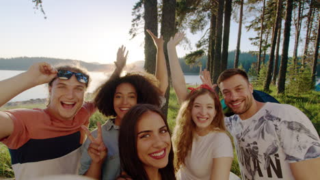 friends having fun camping by the lake