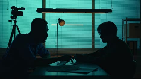 Medium Silhouette Video of a Offender Perpetrator or Prisoner Sitting in the Room the Detective Medium Silhouette Video of a Offender Perpetrator or Prisoner Sitting in the Room the Detective Brings him a Cup of Water and Begins the Interrogation Process True Crime Documentary Creative