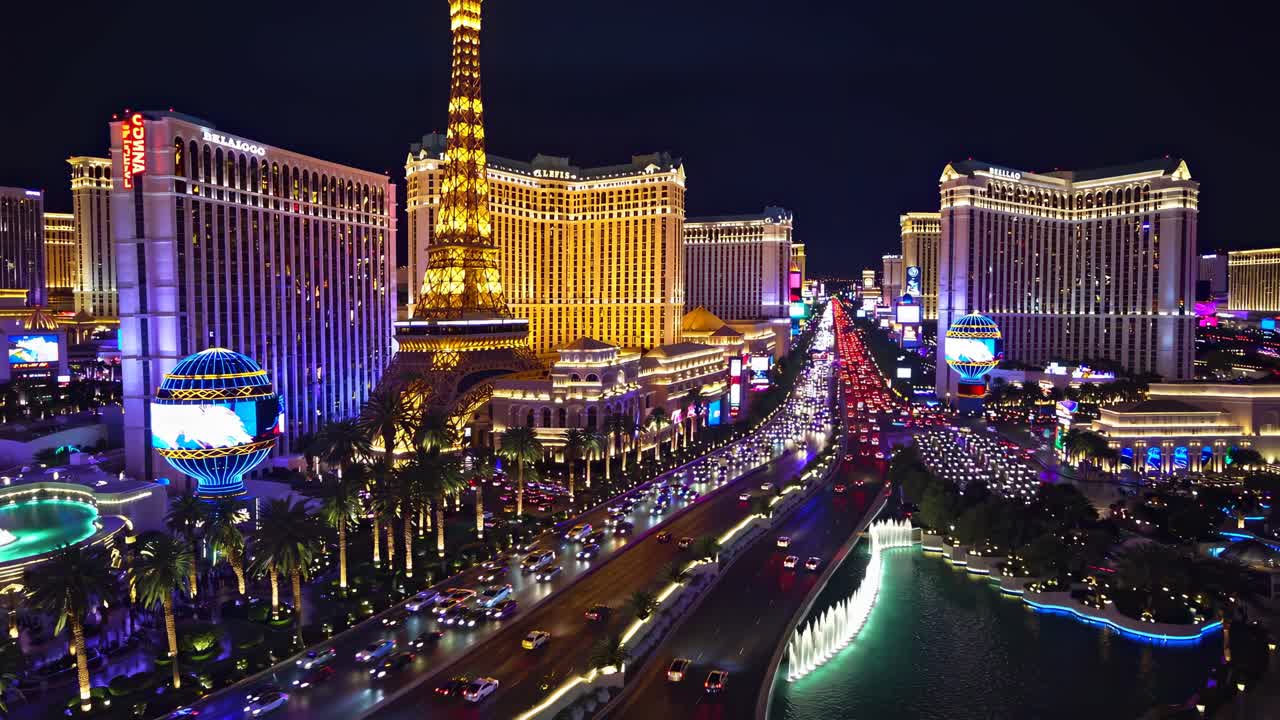 Aerial video of Las Vegas Strip at night, showcasing vibrant neon lights and bustling traffic