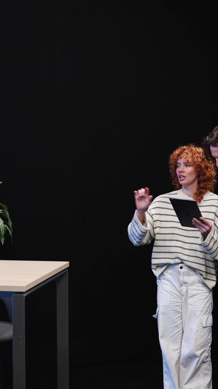 Young Woman and Man Discussing and Setting Up for a Podcast