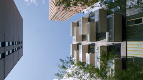 modern buildings against sunny blue sky in zuidas, business district in amsterdam, netherlands