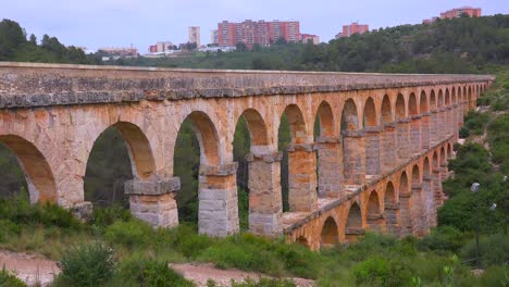 a beautiful roman aqueduct crosses a canyon in france 1