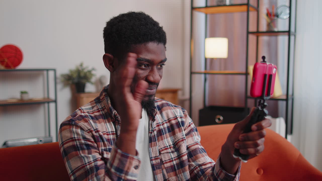 Man blogger influencer taking selfie on smartphone, make virtual social media video online at home