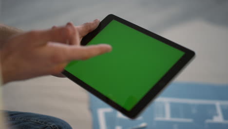 Unknown-people-using-tablet-during-house-renovation.-Man-hand-holding-tablet.