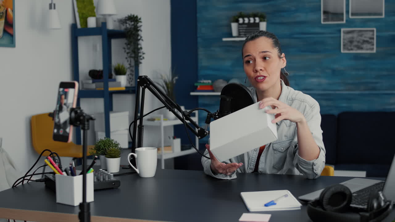 Popular tech enthusiast doing unboxing review video in living room studio